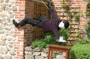 I'm sure that scarecrow's mother is worried about him possibly breaking his neck when he's climbing buildings like this. Still, pretty clever.