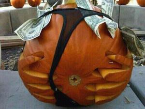 A stripper pumpkin with a thong full of money, now I've seen everything. Still, this pumpkin display would make kids ask their parents, "Why does this pumpkin have its underwear with money?" I don't think they want to answer that.