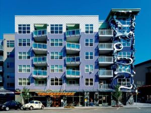 This is actually an apartment building in Seattle, Washington. And while the balconies seem to be a little askew, the right most column seems like it's being consumed by a sea monster.