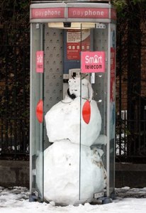 What astounds me most about this display is how the person building this snowman managed to find a phone booth.