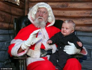 Let's just sum up what makes this Santa terrifying as hell: 1. The ugly wig you'd see on someone playing George Washington. 2. The beard you'd see on a homeless bum. 3. The red hood which doesn't go good on him. Still, I can see why this baby isn't a happy camper.