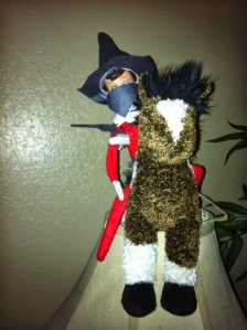 Either this elf on the shelf is an Old West bandit or some 18th century highwayman. Either way, you wouldn't want to mess with him.