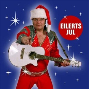 He looks more like the drunken IT guy at the office Christmas party than anything relating to a Santa's helper version of Elvis Presley. Probably passes out in the middle of "Blue Christmas."
