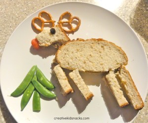 Now this is quite clever with the strawberry nose, the pretzel ears, and the pea pod evergreen tree. Yet, I don't think kids should take this kind of lunch to school. Might ruin the effect.
