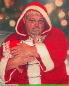 Now this Santa seems so terrifying that even the cat is freaking out. Still, I bet Santa is going to have a lot of scratch marks once this photo op is over.