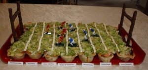 And it looks like the salads in this arrangement is being served in tortilla bowls. Also, is that salad dressing or masking tape?
