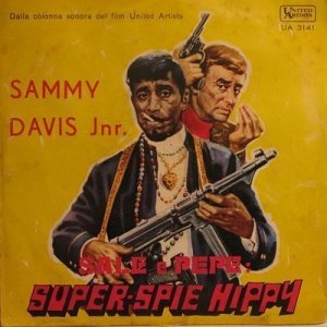 Hate to say this, but Sammy Davis Jr. looks totally like a gangster in this with his bling, leather jacket, smoking his cigarette, and wielding an AK-47 while Lawford seems asking for cash. 