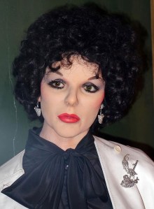 I know she's a famous prime time soap star from the 1970s and 1980s Dynasty. However, that make up job makes her seem like she's either Spock's sister or related to Tim Curry from Rocky Horror Picture Show.