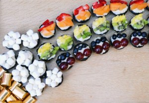 Toppings on these cupcakes include strawberries, cantaloupe, pineapple, kiwi, blueberries, grapes, and marshmallows. Yet, for a second, I thought this was some sort of rainbow sushi configuration.