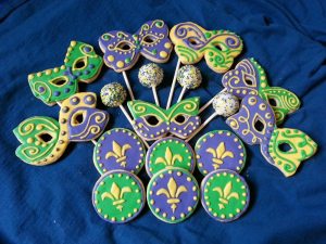 Now this includes cake pops with white icing and sprinkles, coins with a Fleur de Lis, and butterfly masks each unique in their own way.