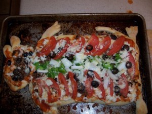 Now this contains tomato sauce, olives, peppers, tomatoes, and cheese. Yet, it seems to resemble a groundhog's insides for some reason. I don't know why.