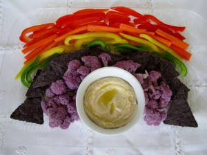 So 3 peppers stand in for red, yellow, and green. Carrots are orange, purple cauliflower is purple, and blue is represented by blue nacho chips, which I assume is the only reason why they have anything to do here.