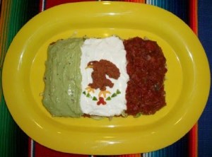 Well, it had stuff sticking out of it so I guess it's a sandwich. Also, it's on a plate. Nevertheless, it's covered with guacamole, cream cheese, refried beans, and salsa.