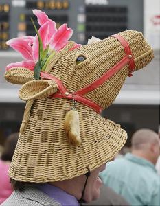 Yes, this guy sure looks pretty with a horse bonnet that has pink lilies on its ears. Also, has a rabbit's foot on it for luck. Guess he has money on a horse.