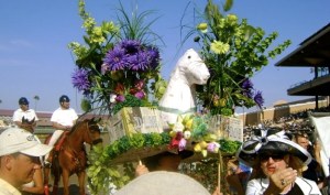 I'm sure the flowers aren't real but they're certainly outrageous compared to the horse. Man, that hat is massive.
