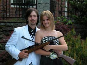 Now it's one thing to take a prom photo with guns. It's a whole different matter when the guy is dressed up like a 1920s gangster. And the fact it's so unintentional makes it even funnier.