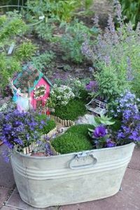 Now this is a quaint scene with a little house, clothes line, swing, and path. But I'm sure the flowers are all regular sized.
