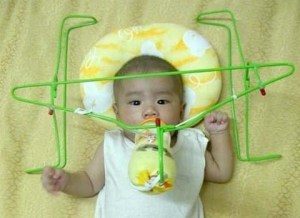 Is it so much effort just to hold a bottle to your child? Or do you have to get a contraption inspired by those beer holders we see at an NFL game? Also doubles as a baby hang glider.