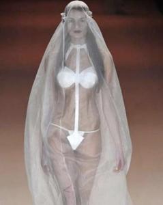 Now this kind of reminds me of a woman in a sci-fi film who's entrenched in a full body bag she can walk in. Well, at least the veil would come in handy protecting her against mosquitoes during her wedding in sub Sahara Africa.