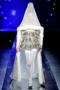 For one, this looks the kind of wedding dress you'd see in a sci-fi movie. Secondly, that veil just looks hideous with the short dress. But I'm sure her face will be fine against the mosquitoes.