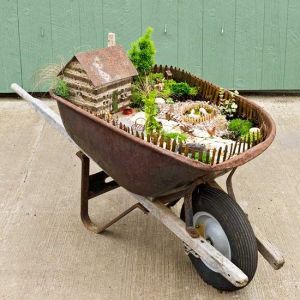 Of course, this place has a lot of plants as well as some farm animals. Still, as a whole it looks wonderful. See I said that you can use any container for a miniature garden. Even a wheelbarrow.