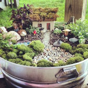Now I like the moss roof on that house along with the moss landscaping. Oh, and the hedgehog is quite cute, too. Seems like ideal fairy abode.