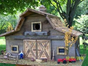 Now this one has a little farmer and tractor. But I have to love the rustic woodwork in this as well as the fine craftsmanship. But I'm sure this is way too small for any actual farm animals.