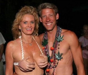 Oh, wait, that's her swimsuit top that resembles hands on her breasts. Also, the guy's wearing a necklace with pot leaves on it. Explains a lot about the woman's swimsuit is picture and the fact that both of them are totally high.