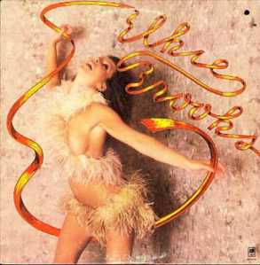 This was Elsie's idea for her album cover. She wanted to get closer to her roots while she was a struggling stripclub dancer at The Gaylord Club. She often wore the feather boa outfit in her act as well as danced with streamers.