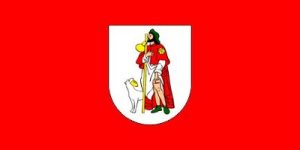 This flag is supposed to be of the shepherd Saint Roch with a leg wound. Beside him is a dog with a loaf of bread in its mouth. According to legend it's said that Saint Roch cut his leg from a rock so he could feed the dog. But the dog found bread instead. What the significance of that event is to an obscure town in Croatia I'll never know. Also, the guy seems to be licking the staff.
