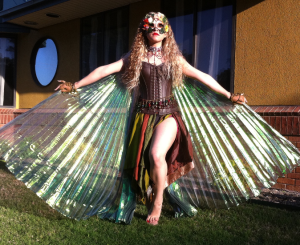 Of course, she's wearing a mask to conceal her identity. She's also wearing a leather corset. But with those wings, she looks quite magnificent.