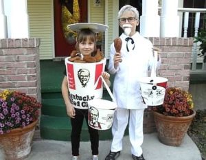 Boy is Colonel Sanders while the girl is a bucket of coronary inducing fried chicken with 11 herbs and spices. Like how they're using KFC buckets for trick or treating.