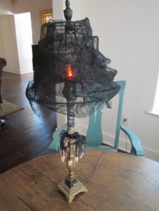 Now that's a spooky lamp with black cob webs galore. Of course, it's a much more tasteful decoration than black lighting.