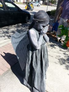 Now you've seen statues like this in cemeteries. But have you seen a child dressed like one? I think not.