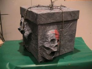 Yes, these are screaming skulls from a box. And it's tied with barbed wire. Scary but don't touch it if you dare.