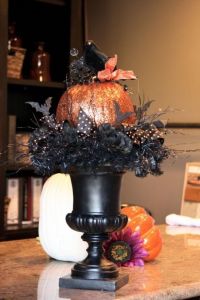 Now this pumpkin is so shiny, especially with the black bird and ribbon on top. Still, I really like the urn and the other decorations on it. So stunning and scary.