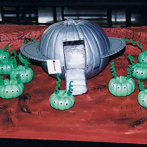Now this is clever. This used a pumpkin as a flying saucer or UFO and small green pumpkins as aliens.
