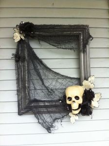 Now this is supposed to resemble cobwebs and skulls with feathers and bones. Yes, it's creative use with picture frames at its finest.