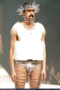 Because this is what the guy's outfit reminds me of, especially around the mouth. Seems like he's hungry for some human sacrifice.