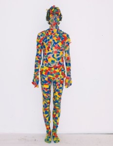 Just a guy with tape all over him. But it looks like confetti to me. Yes, I don't get why this was at a fashion show.