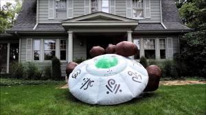 An inflatable flying saucer with inflatable dirt surrounding it. Yeah, that looks very realistic (sarcasm). The one in my lawn ornament post looked more believable.