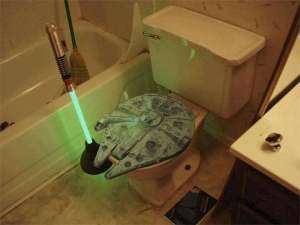 Now at least the Millennium Falcon toilet seat is better than Han Solo in carbonite. However, I'm not sure about the lightsaber plunger. That's just hard to take seriously.