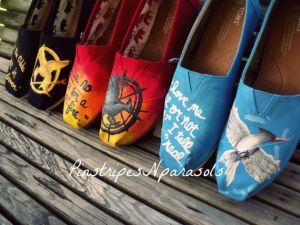 Each has the Mockingjay logo on one shoe and a quote on the other. And all are in the same color as the book covers.