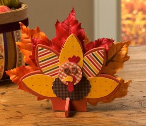Now this is just adorable. Love the wooden and the autumn leaf feathers on this one.