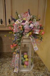 The inside of this is filled with tiny decorated Easter eggs. The outside has a quality Easter bow and flowers.