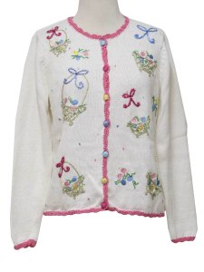 From all the sweaters I've put on this post so far, this first one that doesn't have a single animal in sight. Just baskets, eggs, and flowers.