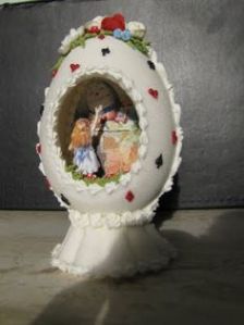 The card suite shell is rather fitting for the story. But what you see inside can make you curiouser and curiouser.