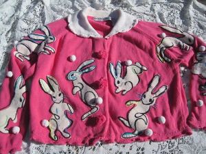 Indeed they do. But on this pink cardigan, there are some pom poms unattached to bunnies as well.