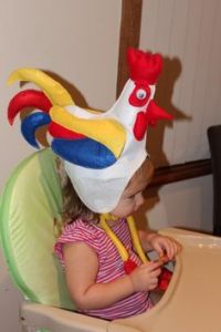 Yes, that's a little rooster hat for a small child. And I'm sure this little girl would fit in with an Easter parade perfectly.