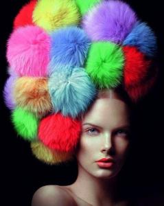 To me this either resembles a clown afro or her coiffe being taken over by rainbow tribbles. I'm not sure which is which.